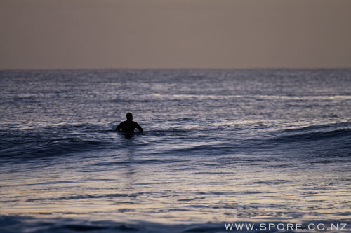 surfer waiting for taranaki waves